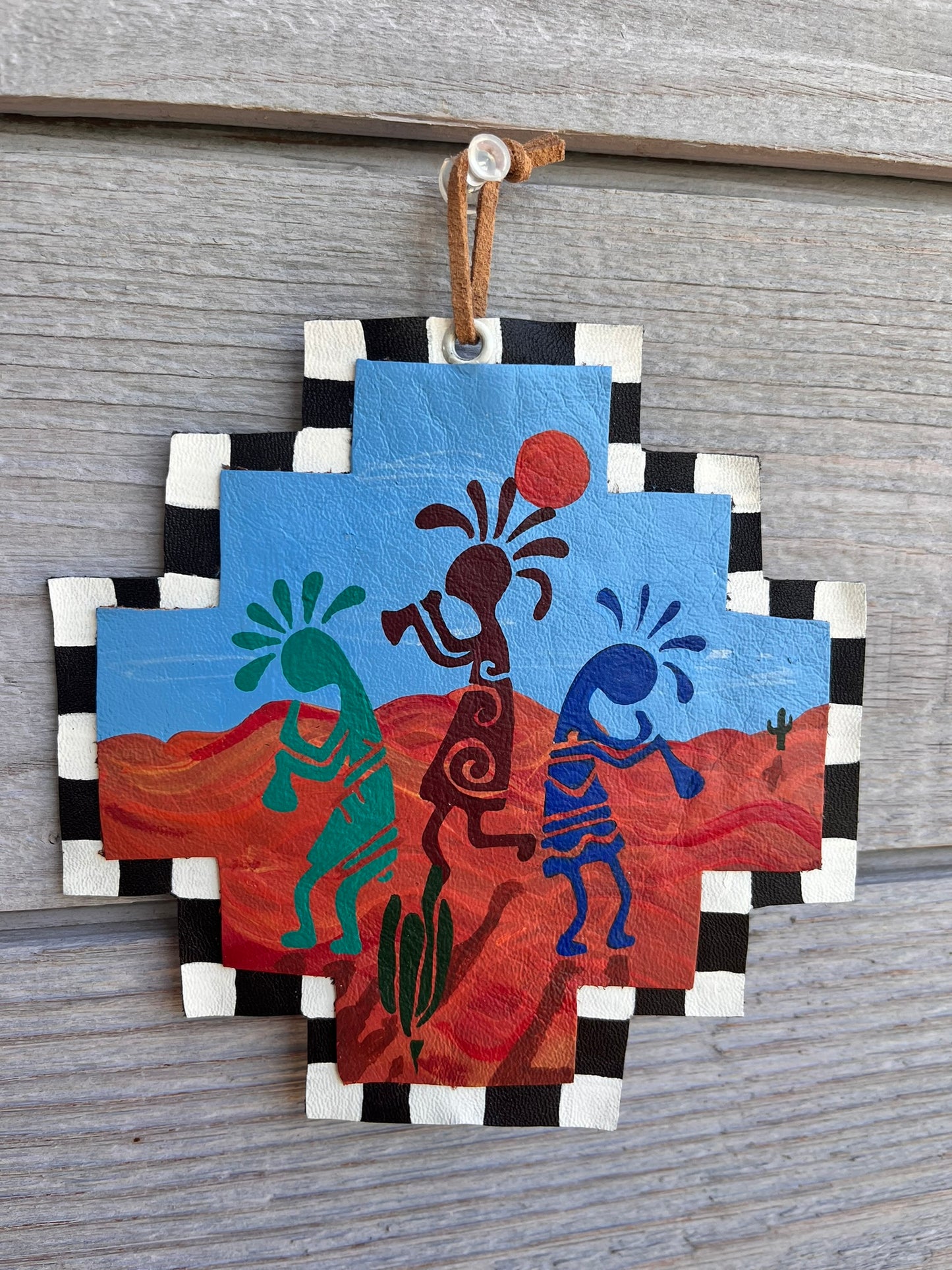 Painted leather ornament kokopelli